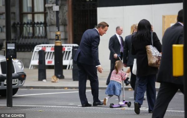 英国首相卡梅伦步行送女儿上幼儿园。