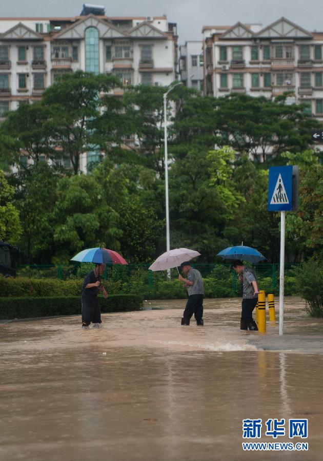 5月11日，人们在深圳西丽涉水行走。