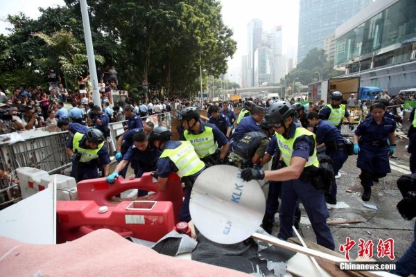 10月14日，警方清除金钟道障碍物。大批警员在金钟道现场清拆障碍物。部分警员戴上头盔将障碍物移走。